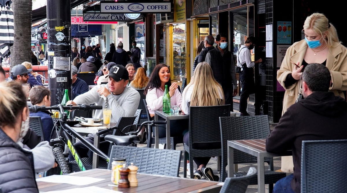 Diners eat outside St Kilda's Rococo restaurant on the second day of eased Covid regulations, following a lockdown to curb an outbreak, in Melbourne, Australia on Oct 23, 2021. (Reuters)