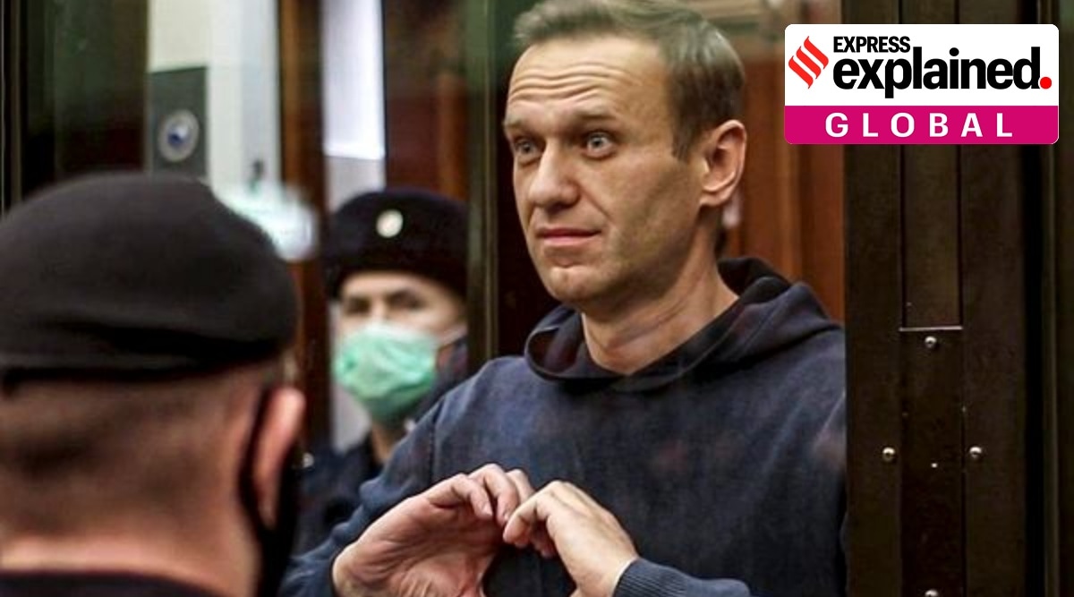  Russian opposition leader Alexei Navalny shows the heart symbol from the cage, during a hearing at the City Court in Moscow, Russia.  (AP)