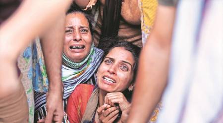 Jammu teacher Deepak Chand’s wife Anuradha before his cremation on Friday. (AP)