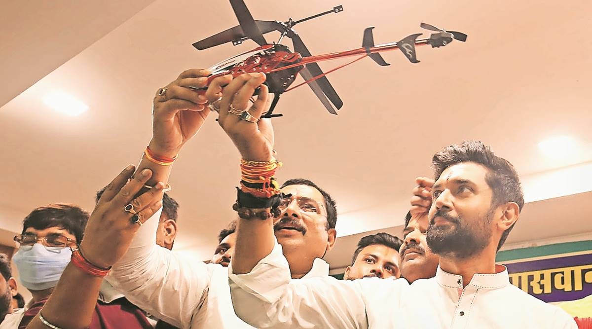 Chirag Paswan holds aloft his party’s poll symbol in Delhi on Thursday. (Express Photo: Anil Sharma)