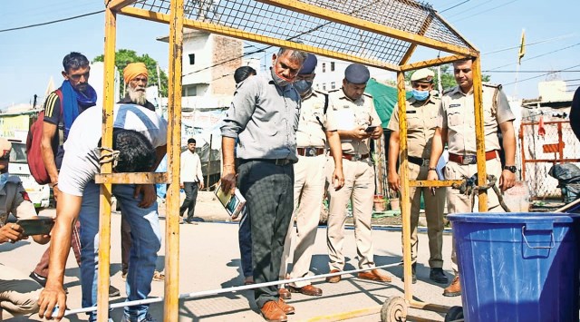 Police near the site where the body was found at the Singhu border on Friday. (Photo: Amit Mehra)