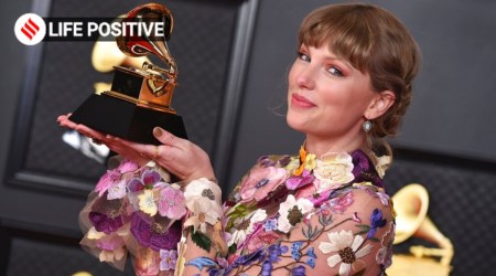 Taylor Swift poses in the press room with the award for album of the year for "Folklore" at the 63rd annual Grammy Awards. (Source: Jordan Strauss/Invision/AP)