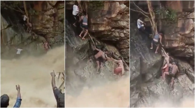 Screengrabs from the video shows a mother and baby being rescued from beside a raging waterfall. 