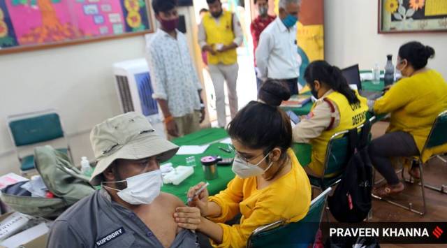 Beneficiaries take a shot of Covid-19 vaccine at a vaccination centre in New Delhi. (Express photo by Praveen Khanna)