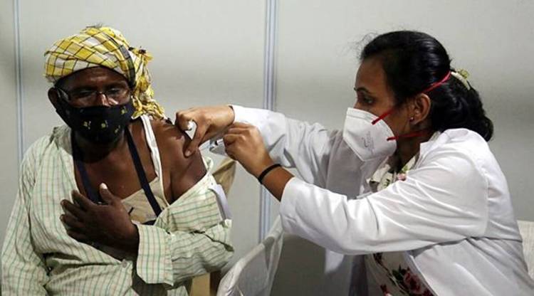 A health worker administers Covid-19 vaccine dose to a beneficiary at Matasundri college in New Delhi. (Express File Photo)