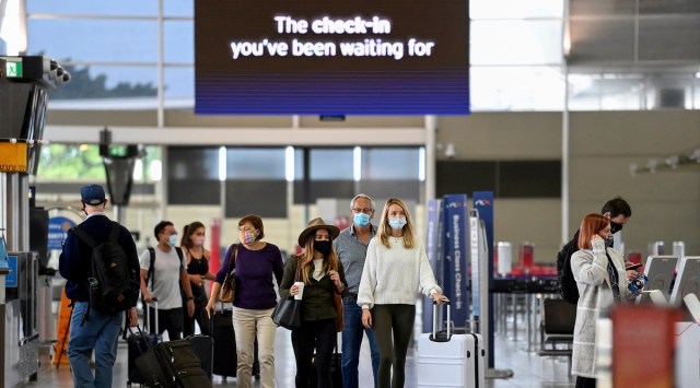 Passengers wear face masks as they arrive at the departures terminal at Sydney Domestic Airport in Sydney, Australia Friday, Nov. 5, 2021. (AP)