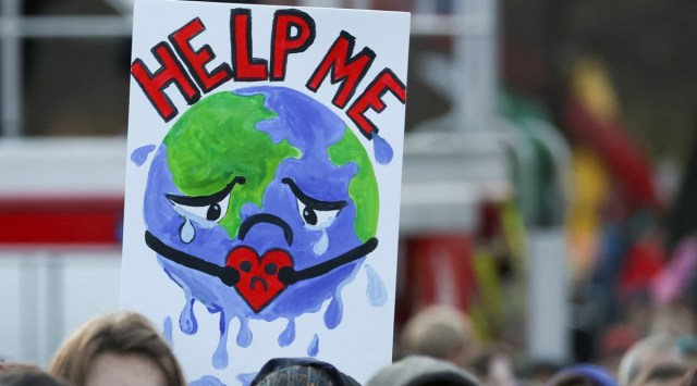 People carry a sign as they attend a protest during the UN Climate Change Conference (COP26), in Glasgow, Scotland, Britain, November 6, 2021. (Reuters)