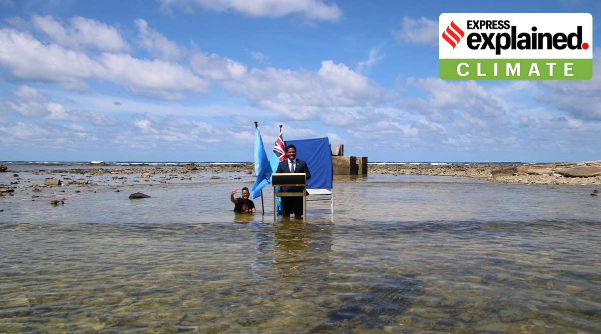 Tuvalu's Minister for Justice, Communication & Foreign Affairs Simon Kofe gives a COP26 statement while standing in the ocean in Funafuti, Tuvalu November 5, 2021. (Reuters)