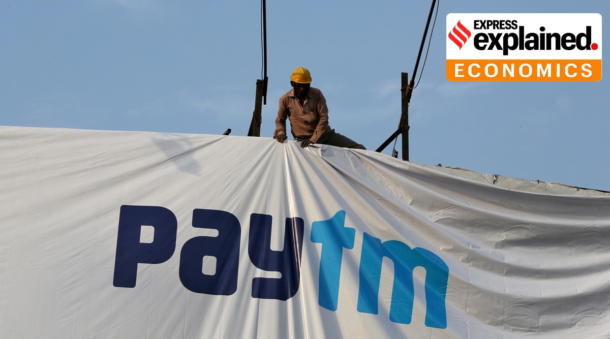 A worker adjusts a hoarding of Paytm, a digital payments firm, in Ahmedabad (Reuters)