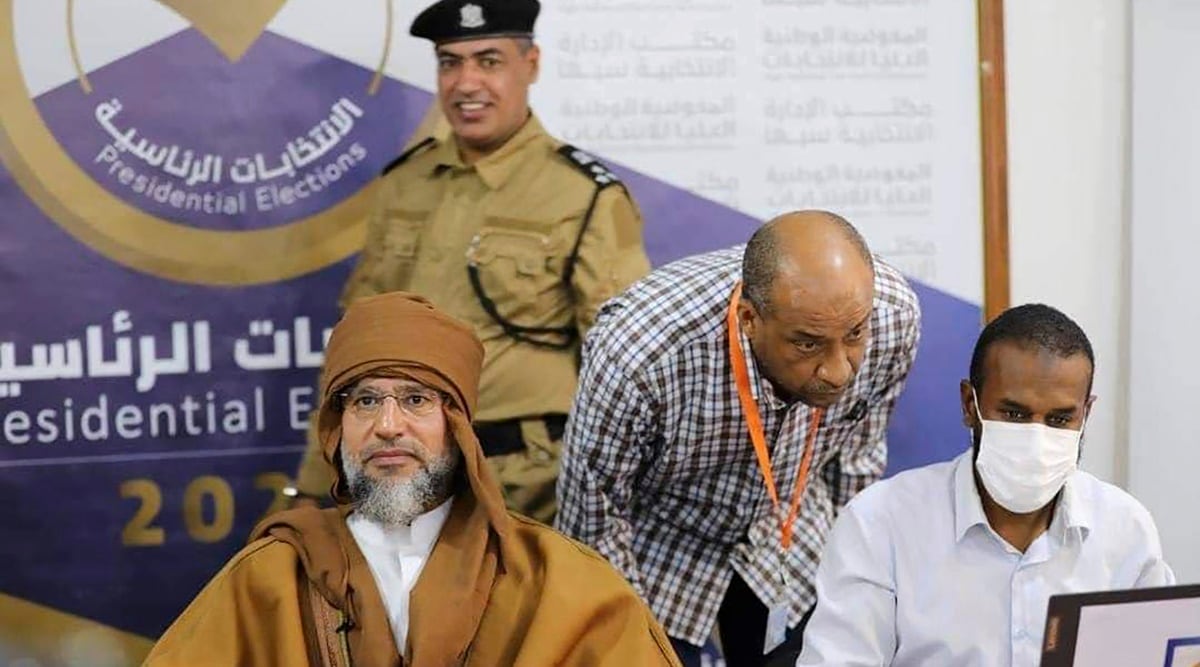 Seif al-Islam, left, the son and one-time heir apparent of late Libyan dictator Moammar Gadhafi registers his candidacy for the country's presidential elections next month, in Sabha, Libya, Sunday, Nov. 14, 2021. (AP)