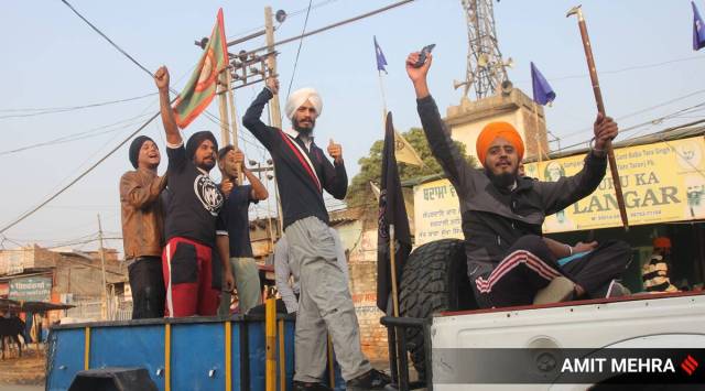 Farmers celebrate after the repeal of the farm laws on November 20. (Express Photo/Amit Mehra)