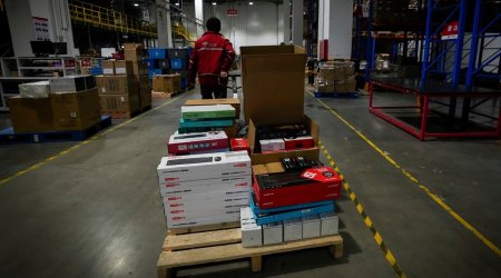 A worker pulls a trolley loaded with computer accessories at the Chinese online retailer JD.com's warehouse in Beijing on Tuesday, Nov. 9, 2021. China's biggest online shopping day, known as "Singles' Day" on Nov. 11, is taking on a muted tone this year as regulators crack down on the technology industry and President Xi Jinping pushes for "common prosperity." (AP Photo)