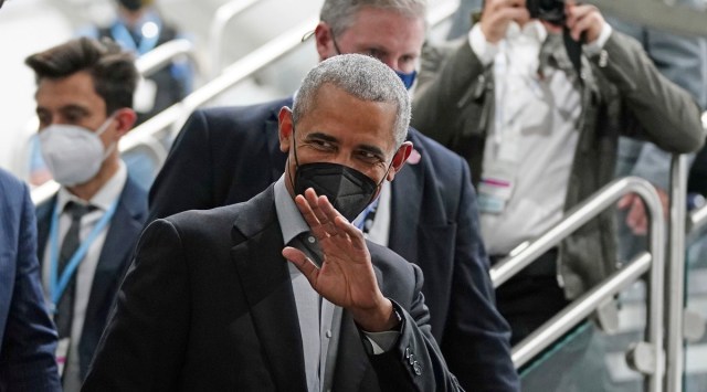 Former US President Barack Obama waves as he arrives at an event during the COP26 UN Climate Summit in Glasgow, Scotland. (AP)