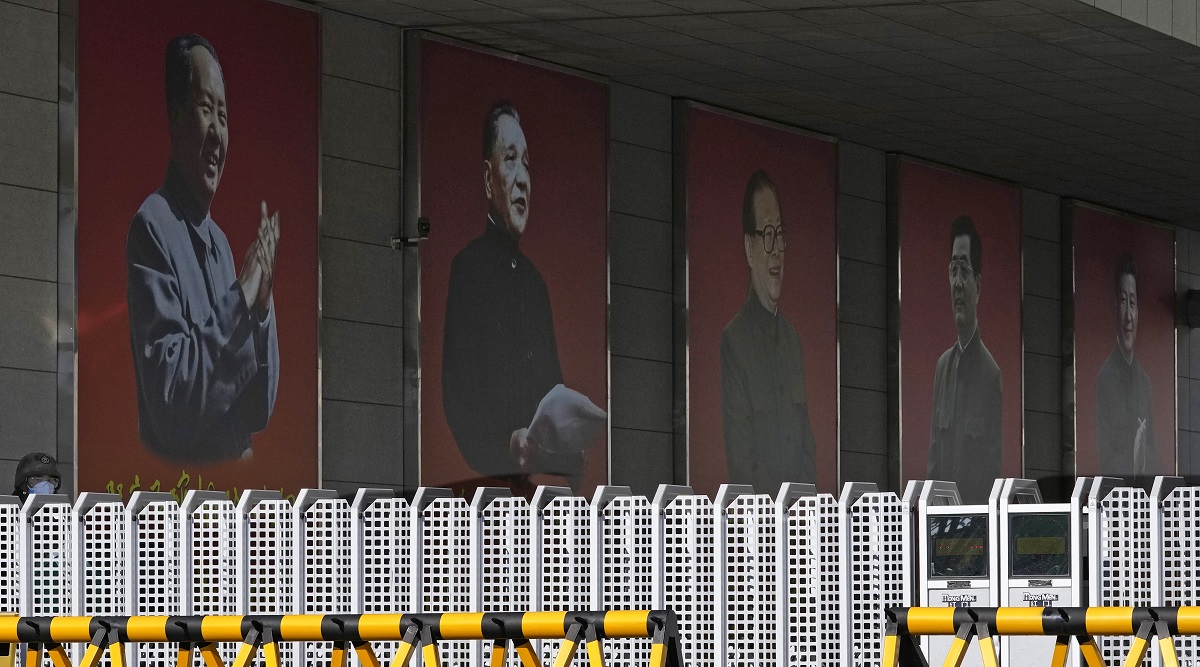Portraits of China's former top leaders from left Mao Zedong, Deng Xiaoping, Jiang Zemin, Hu Jintao and including the current President Xi Jinping are seen at a military camp in Beijing. (AP)