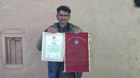 Abdul Latief Magray holding citations for his bravery award. (Express Photo)