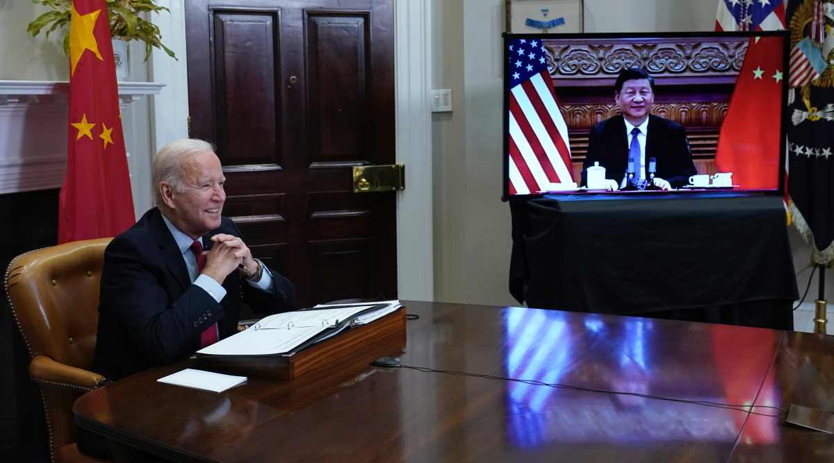 President Joe Biden, left, speaks as he meets virtually with Chinese President Xi Jinping, on screen, from the Roosevelt Room of the White House in Washington, Monday, Nov. 15, 2021. (AP Photo/Susan Walsh)