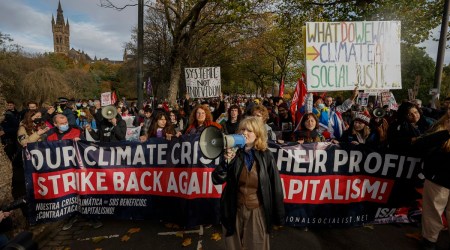 Climate activists march through the streets of Glasgow, Scotland on Friday, Nov. 5, 2021. (Kieran Dodds/The New York Times)