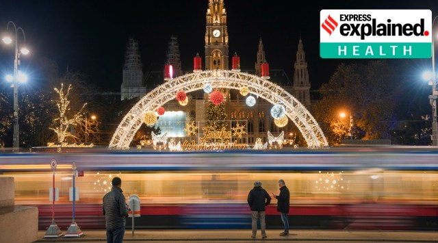 People wait for the tram, backdropped by the Christmas market, now closed due to the national Covid-19 lockdown, in Vienna. (Photo: AP)