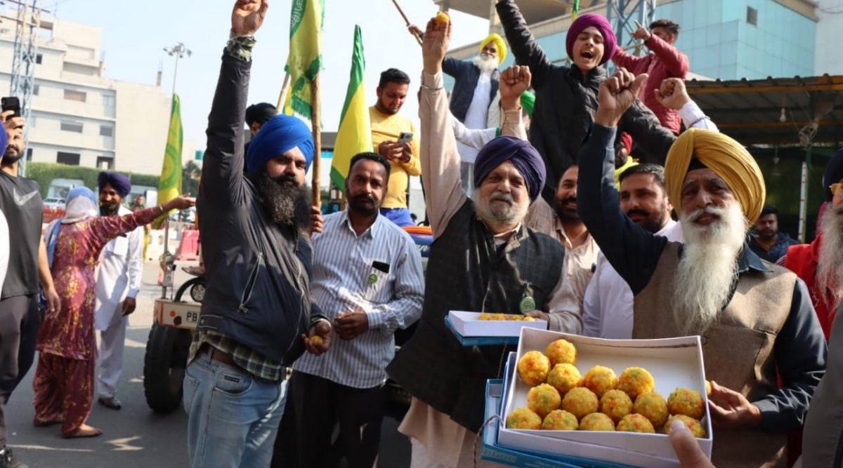Farmers celebrate at a protest site in Ludhiana’s Ferozepur Road on Friday. (Express Photo by Gurmeet Singh)