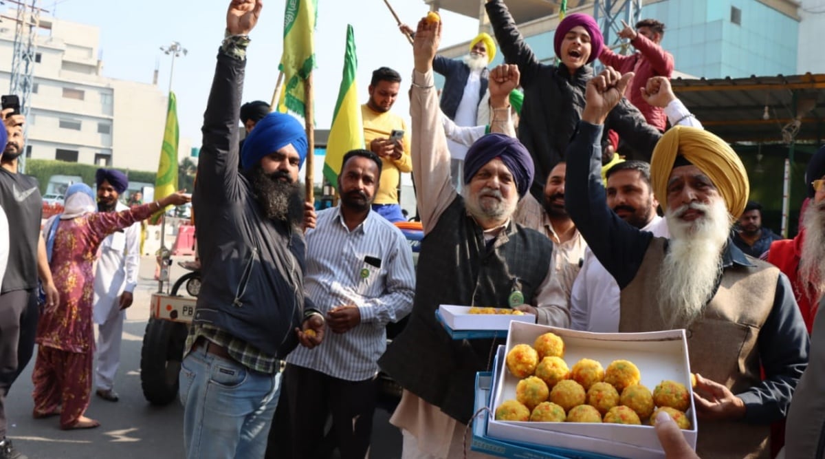 Farmers celebrate at a protest site in Ludhiana’s Ferozepur Road on Friday. (Express Photo by Gurmeet Singh)