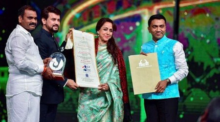 Union minister Anurag Thakur presents the Indian Film Personality of the Year award to Hema Malini in Panaji on Saturday. (PTI)