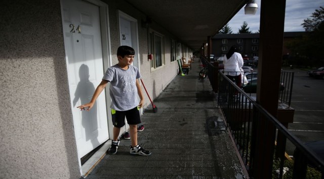 Mansoor, 10, walks out the door to look outside at the family's new apartment in Tukwila, Washington, U.S. November 3, 2021.  3, 2021. REUTERS/Lindsey Wasson



