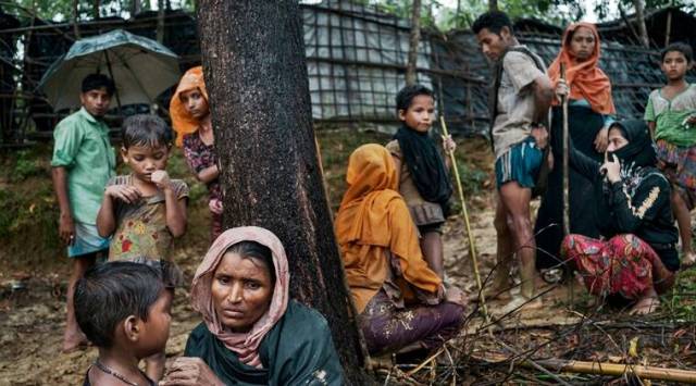 Rohingya refugees from Myanmar rest near a refugee camp after crossing the border illegally near Amtoli, Bangladesh. (File photo by Adam Dean/The New York Times)
