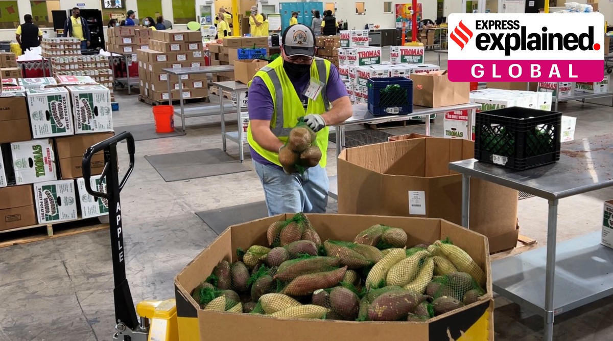 A worker puts bags of sweet potatoes in container in the warehouse of the Alameda County Community Food Bank in Oakland, Calif., on Nov. 5, 2021. (AP Photo/Terry Chea)