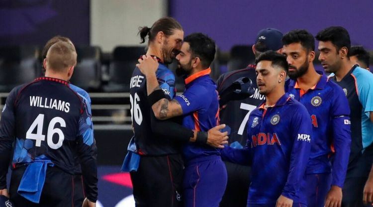 India's captain Virat Kohli hugs Namibia's David Wiese as he leads team members out into the field after winning the Cricket Twenty20 World Cup match between India and Namibia in Dubai, UAE, Monday, Nov. 8, 2021. (AP Photo/Aijaz Rahi)