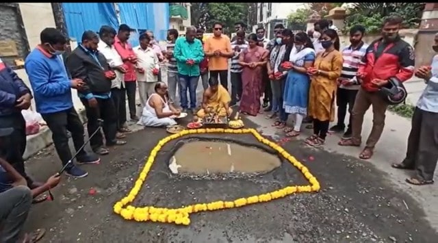 The residents Tuesday morning garlanded potholes on the roads, lit incense sticks and performed rituals and a video of the puja went viral. (Screengrab)
