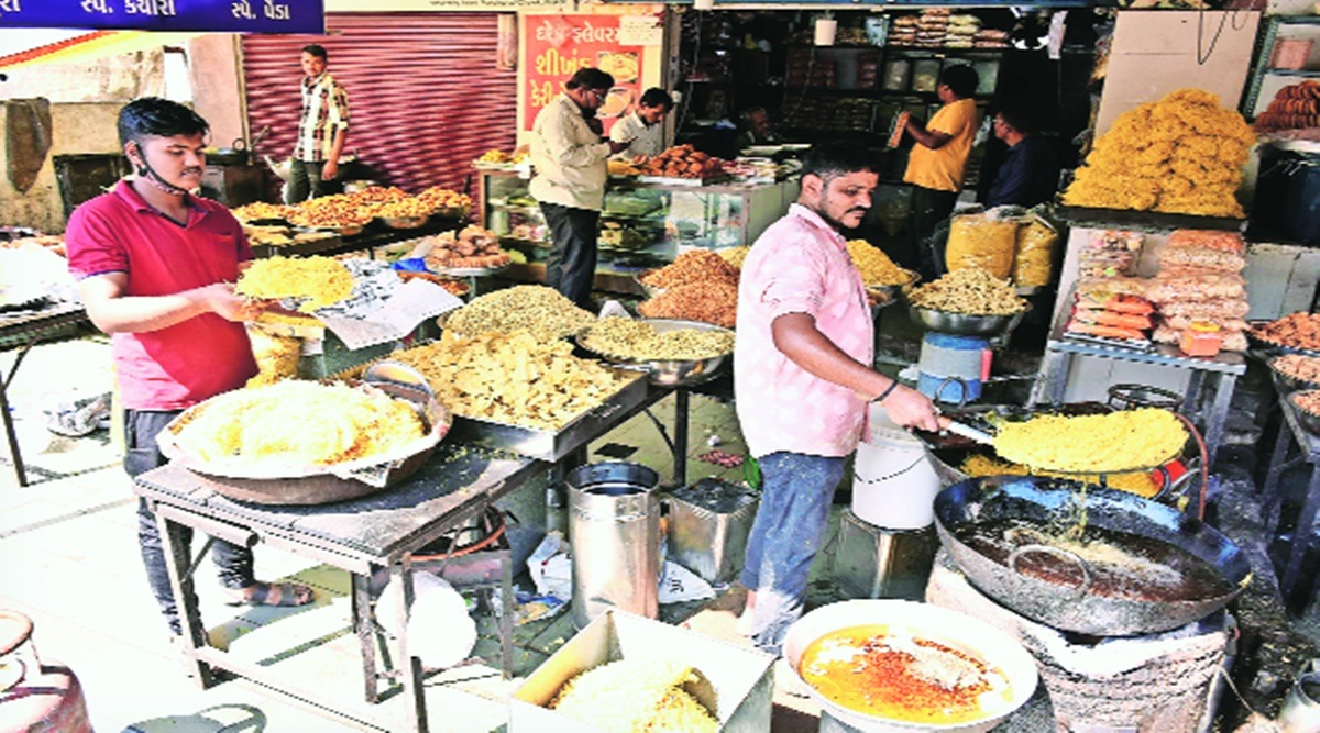 Sweets are packed at Shivshakti Dairy Farm; Workers make farsan at Kailas Farsan on University Road in Rajkot. Chirag Chotaliya