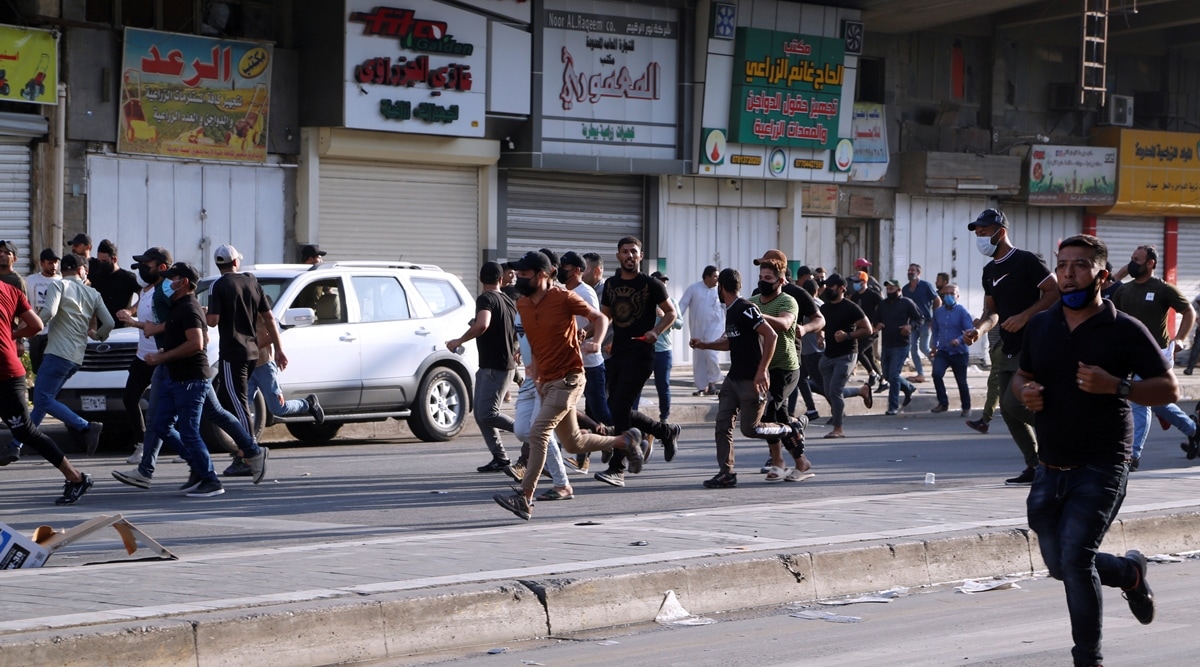 Supporters of Iraqi Shiite armed groups run from security forces after clashes during a protest against the election results in Baghdad, Iraq on November 5, 2021. (Reuters)