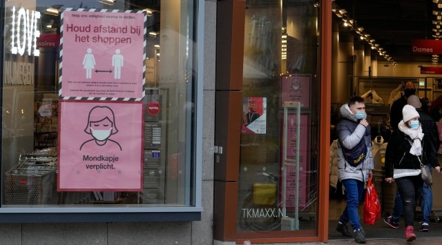 Signs warn shoppers of mandatory face mask and the need to respect social distancing in Nijmegen, eastern Netherlands. (AP)