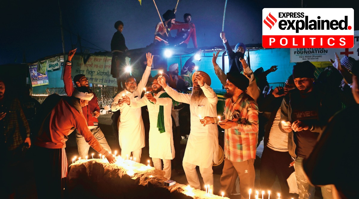 Farmers celebrate the announcement of the repeal at the protest site on the Singhu border on Friday. (Photo: Praveen Khanna)