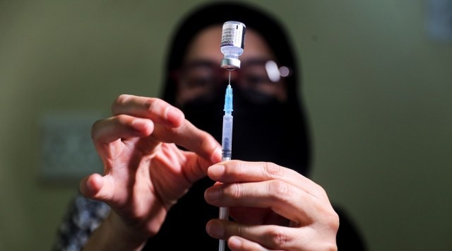A pharmacist prepares a dose of the coronavirus disease Pfizer vaccine amidst the spread of the SARS-CoV-2 variant Omicron in Johannesburg, South Africa, December 4, 2021. (Reuters)