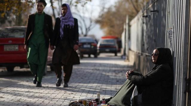 Hadia Ahmadi, 43, was a teacher in various schools under the previous Afghan government, but she lost her job due to education restrictions for children and job restrictions for women. Now she waxes shoes for people along the street in Kabul. (Reuters)