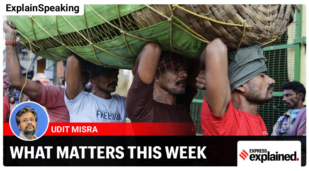 Labourers carry a load of vegetables at a wholesale market in Kolkata (AP)