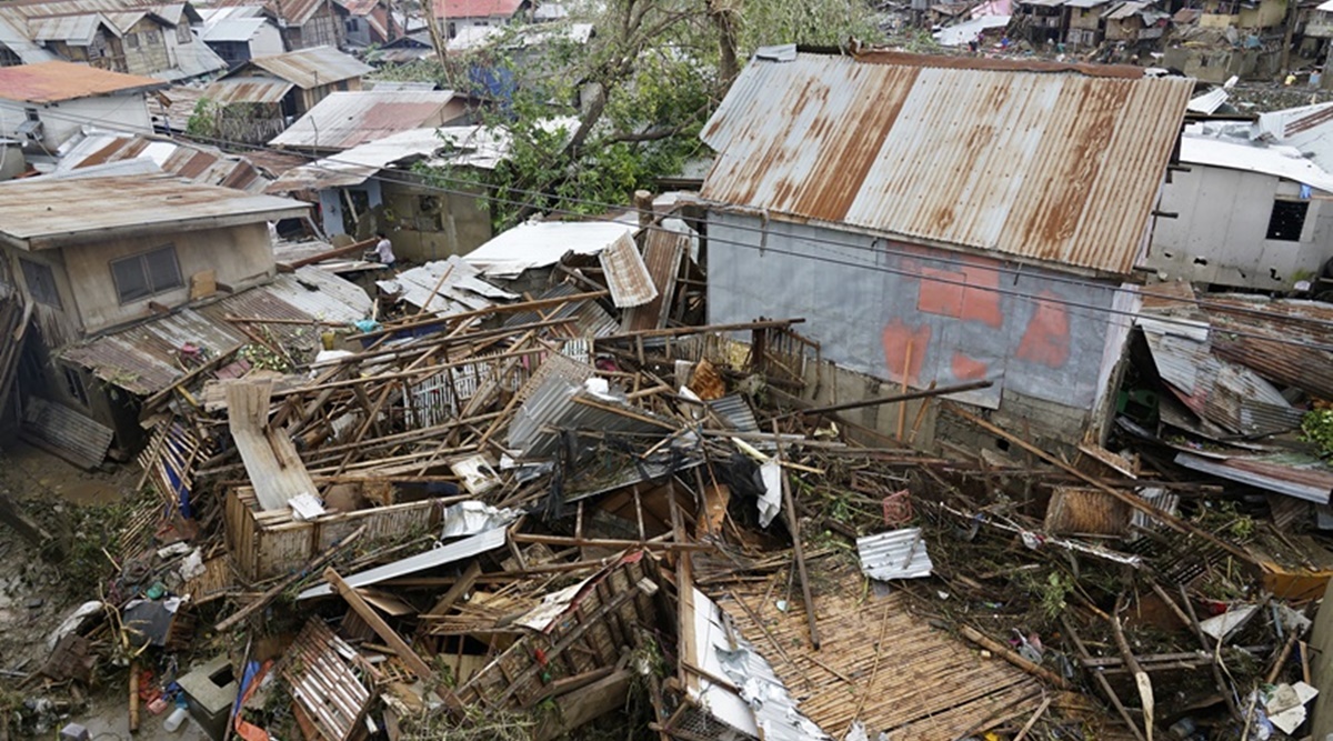 Debris is scattered over damaged homes from Typhoon Rai in Talisay, Cebu province, central Philippines on Friday, Dec. 17, 2021. (AP Photo/Jay Labra)