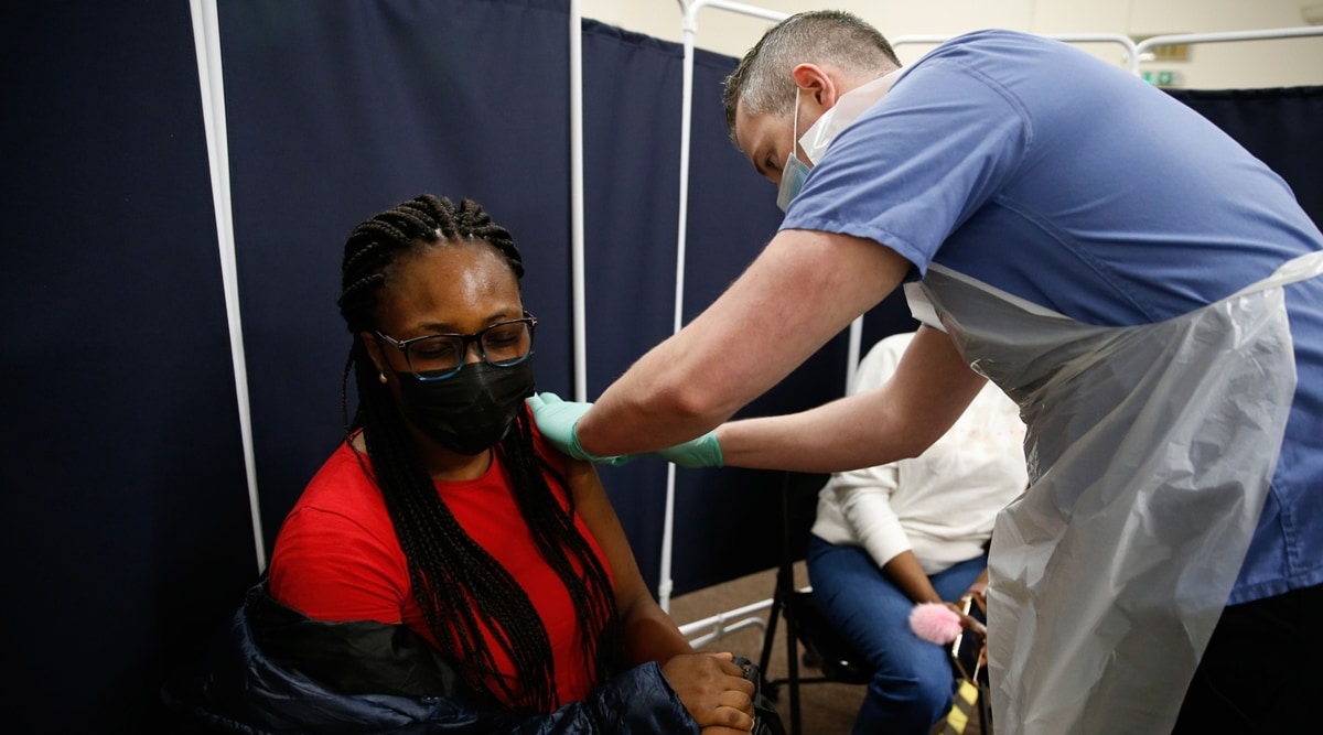 A visitor recieves her first dose of the AstraZeneca Covid-19 vaccine in Stratford, London, UK, on Monday, March 22, 2021. (Bloomberg)