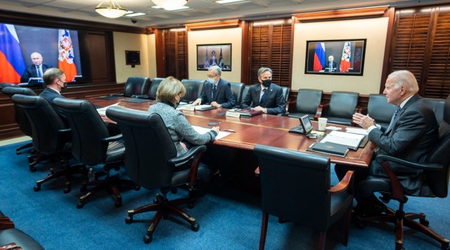 A photo provided by the White House shows US President Joe Biden, right, at the White House in Washington, as President Vladimir Putin of Russia appears on video monitors during their virtual meeting on Tuesday, Dec. 7, 2021.  (White House via The New York Times)