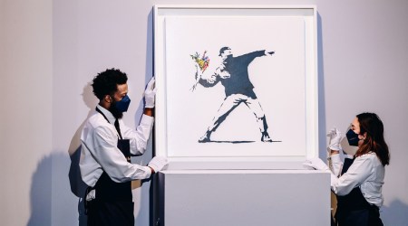 Banksy's “Love Is in the Air” is displayed during an auction at Sotheby's in New York, May 12, 2021. (Nina Westervelt/The New York Times)