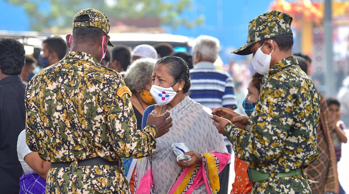 Bengaluru: Bruhat Bengaluru Mahanagara Palike (BBMP) marshals ask citizens to wear a mask amid fear of spread of a new variant of COVID-19, in Bengaluru, Friday, Dec. 3, 2021.(PTI Photo/Shailendra Bhojak)