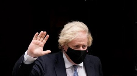 British Prime Minister Boris Johnson waves to the media as he leaves 10 Downing Street. (AP)