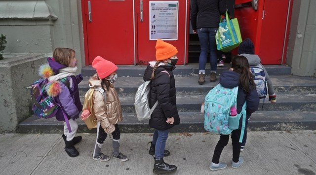 Children line up to attend class during the coronavirus disease pandemic in the Manhattan borough of New York City. (Reuters)