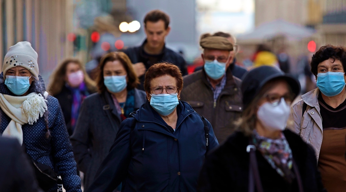 People wearing face masks to curb the spread of Covid-19 walk in Lisbon. (AP)