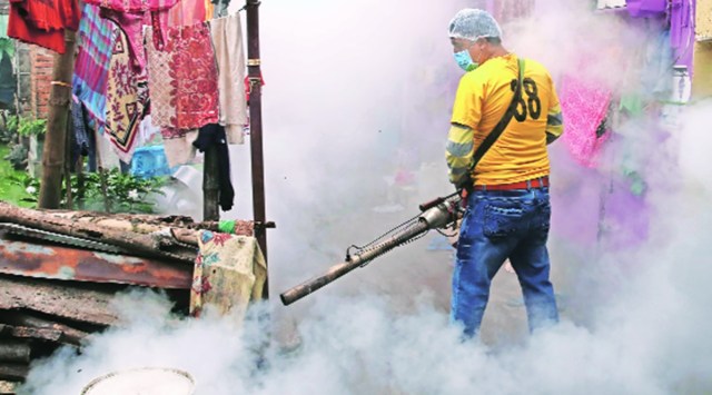 A civic worker fumigates in an area in Kolkata. (Express Photo by Partha Paul)