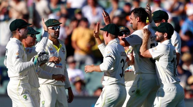 Australian players celebrate the wicket of England's Jos Buttler during the third day of their Ashes cricket test match in Adelaide, Australia, Saturday, Dec. 18, 2021. (AP Photo/James Elsby)
