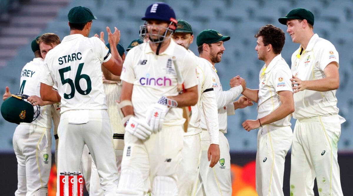 England's James Anderson, center, waits as Australia celebrate their victory on the fifth day of their Ashes cricket test match in Adelaide, Australia, Monday, Dec. 20, 2021. Australia wins the match by 275 runs. (AP Photo/James Elsby)