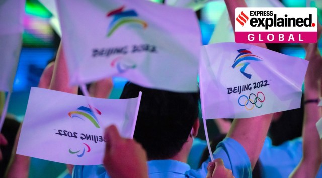 Participants wave flags before a launch ceremony to reveal the motto for the Winter Olympics and Paralympics in Beijing on Sept. 17, 2021. (AP Photo/Mark Schiefelbein, File)


