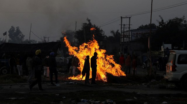 Farmers vacate a protest site, after the government agreed to their demands, including assurance to consider guaranteed prices for all produce, at the Singhu border. (Reuters)